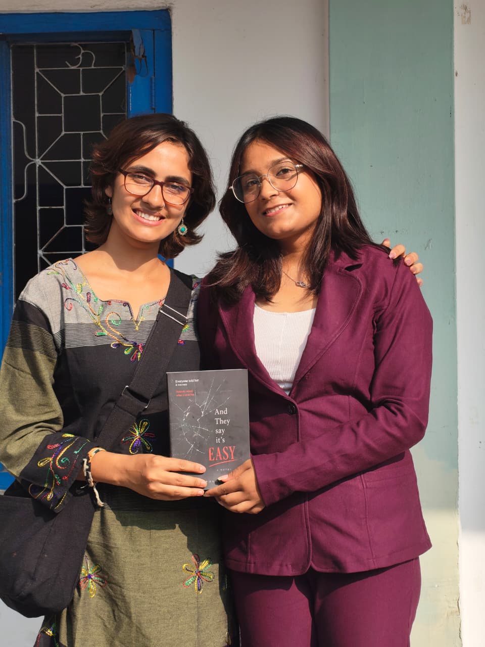 Shreya with a reader holding the book
